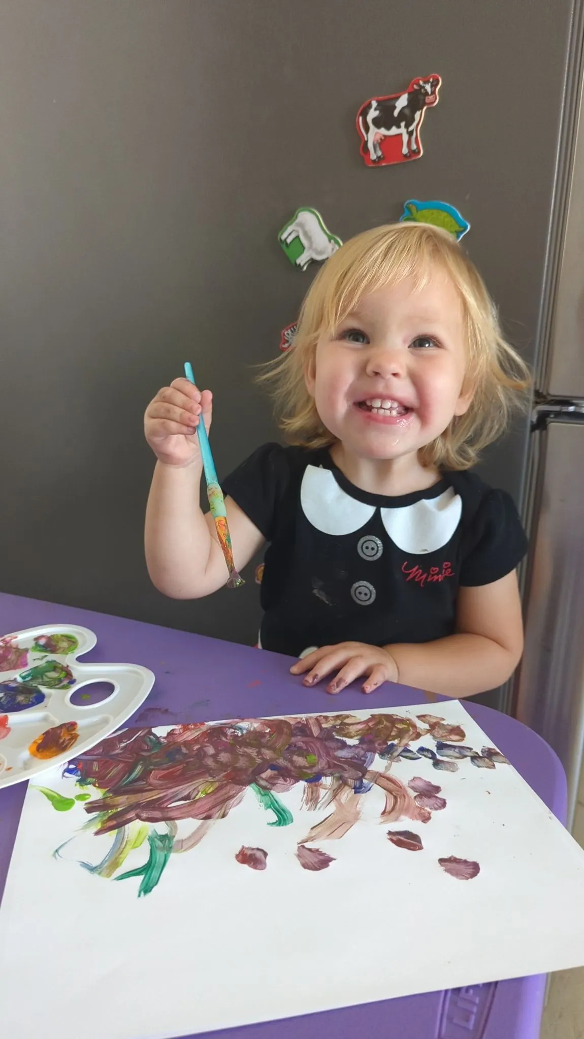 Smiling toddler at a table
