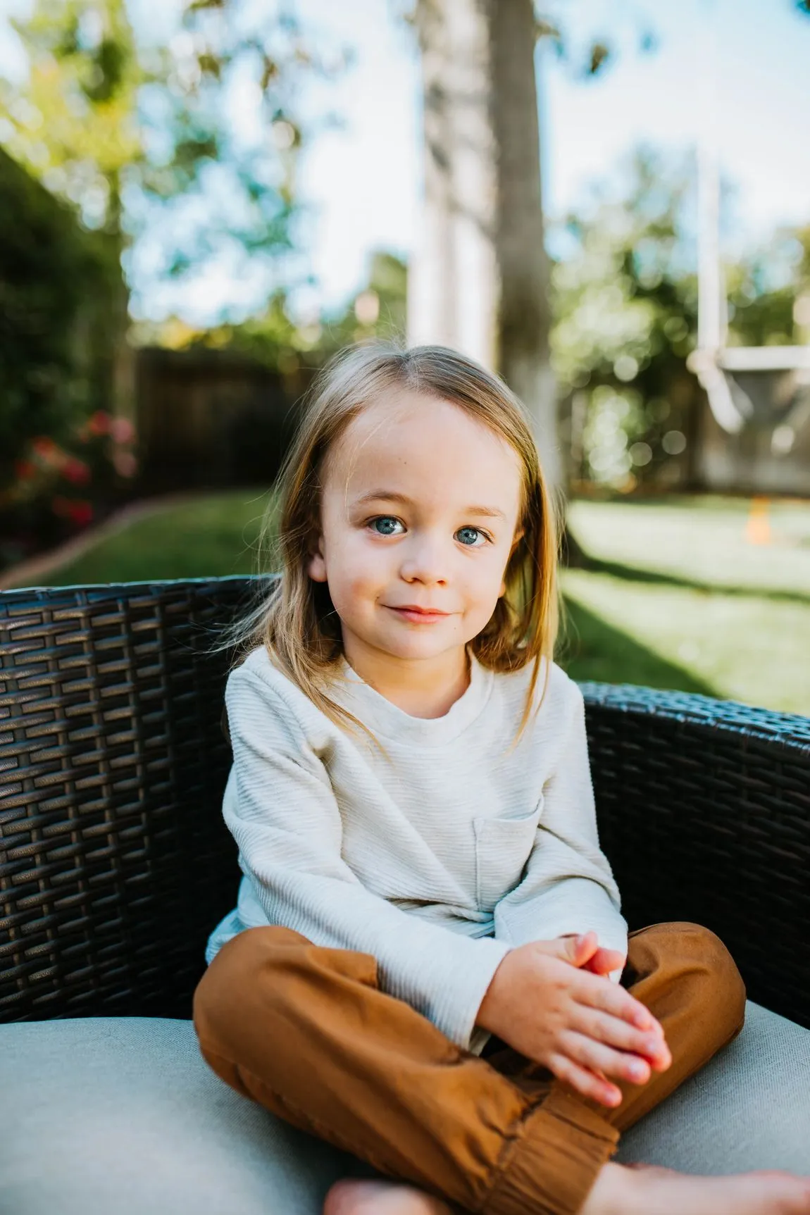 Smiling toddler sitting outside