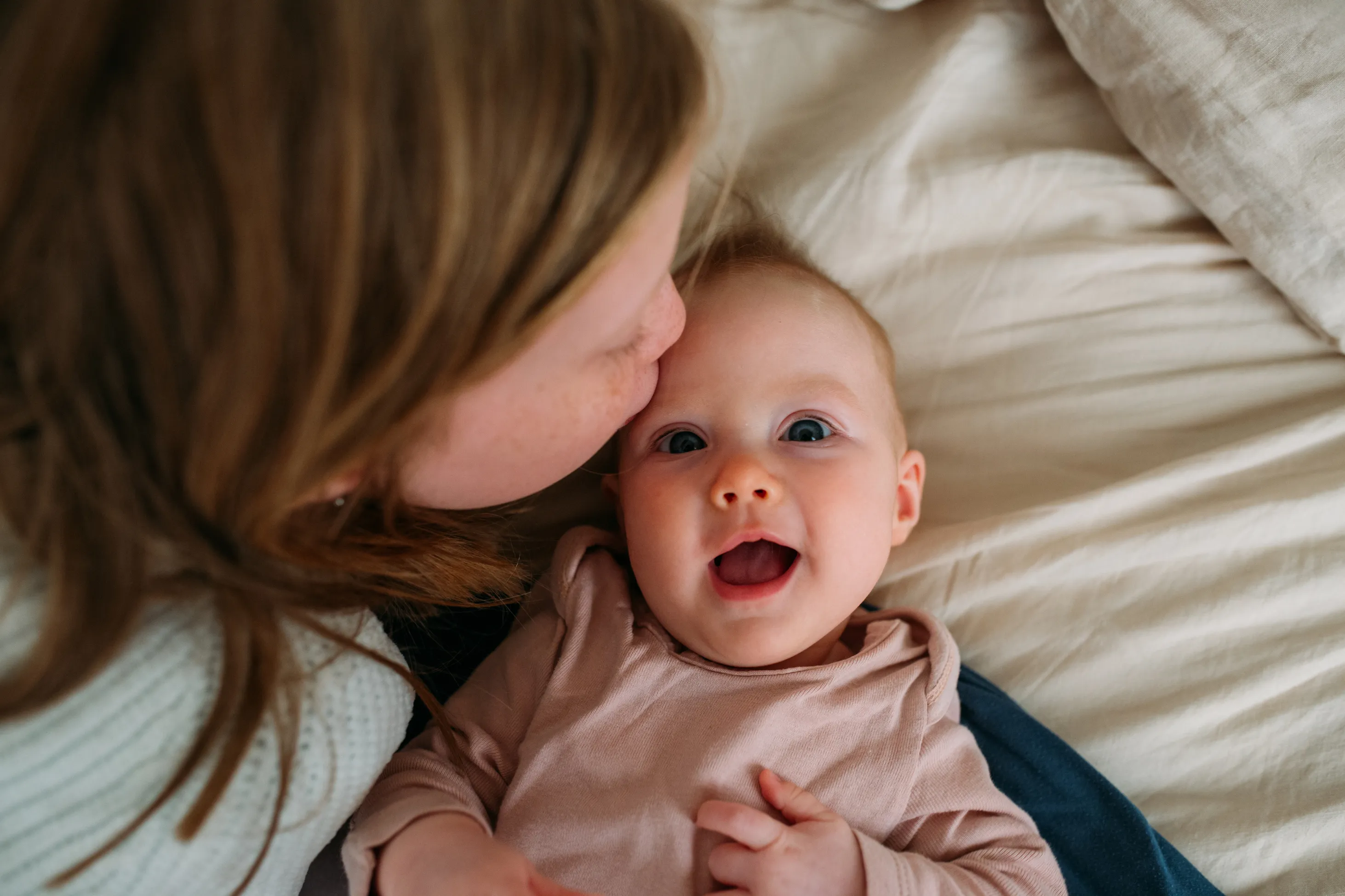 Mother kissing her baby