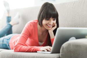 woman looking at fertility apps on her laptop